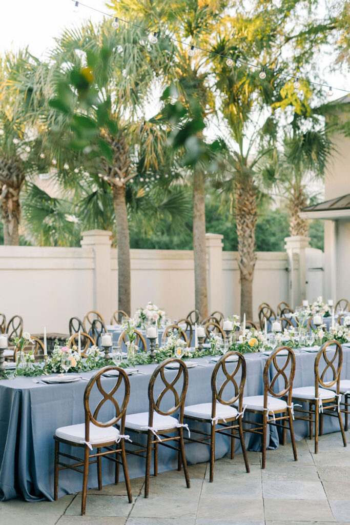 Outdoor wedding reception beneath palm trees at a historic destination venue