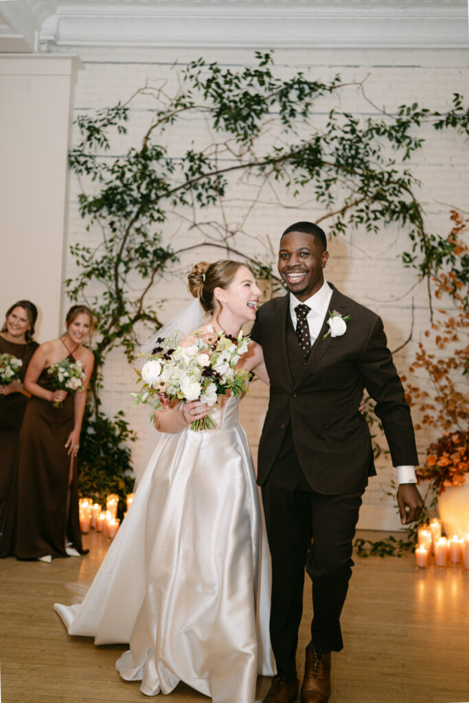 Smiling newlyweds leaving their candlelit wedding ceremony at Gordon Green