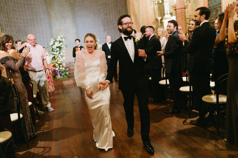 Newlyweds leaving their ceremony at a historic New Orleans wedding venue