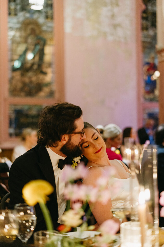 Newlyweds sharing a quiet moment during their candlelit New Orleans reception