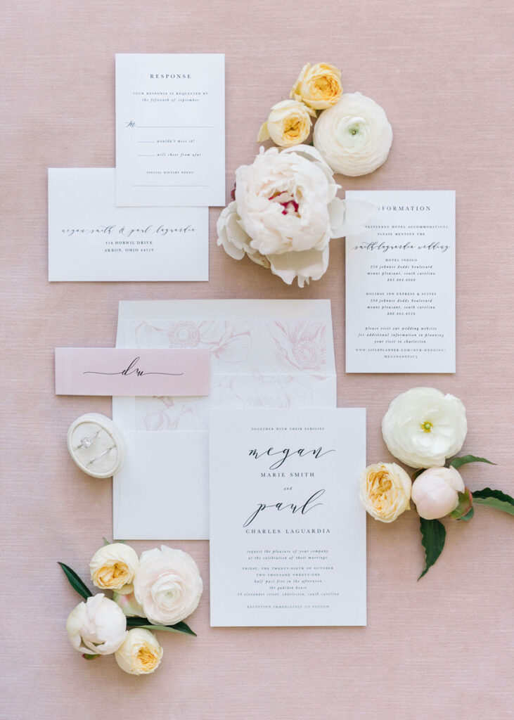 Blush wedding invitation suite with white and yellow flowers